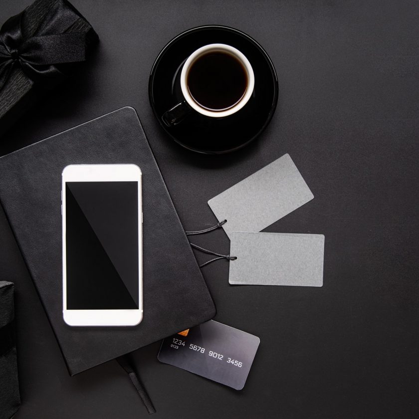 black-smartphone-price-tags-coffee-and-gifts-top-view-on-black-background.jpg